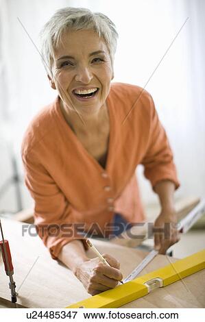 Stock Photo - woman doing mechanical skills. Fotosearch