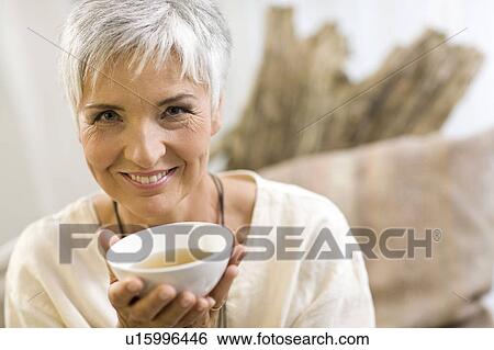 Woman drinking tea View Large Photo Image Stock Photograph - Woman drinking tea. Fotosearch