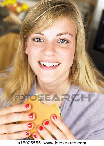 Woman eating an hamburger View Large Photo Image Stock Photography - Woman eating an hamburger. Fotosearch