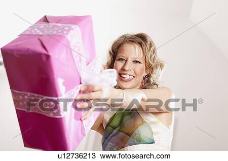 woman handing over present View Large Photo Image Stock Image - woman handing over present. Fotosearch