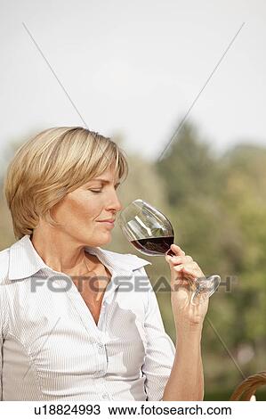 Woman holding a glass of wine View Large Photo Image Stock Image - Woman holding a glass of wine. Fotosearch