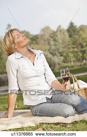 Stock Photography - Woman holding a glass of wine. Fotosearch