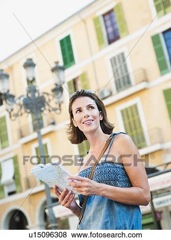 woman holding map looking around View Large Photo Image Stock Photo - woman holding map looking around. Fotosearch