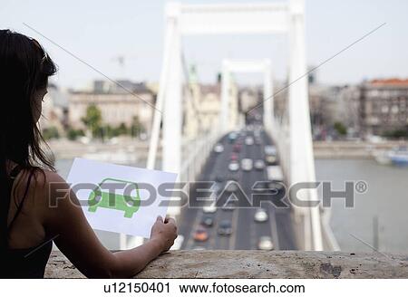 Woman holding paper green car View Large Photo Image Stock Image - Woman holding paper green car. Fotosearch