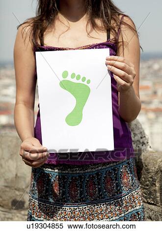 Woman holding paper green foot View Large Photo Image Stock Photography - Woman holding paper green foot. Fotosearch