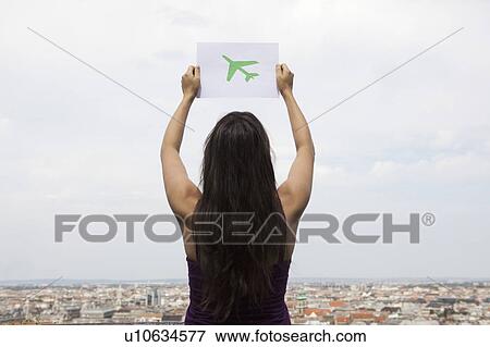 Woman holding paper green plane View Large Photo Image Stock Photo - Woman holding paper green plane. Fotosearch