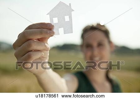 Woman holding up cut-out paper house View Large Photo Image Stock Image - Woman holding up cut-out paper house. Fotosearch