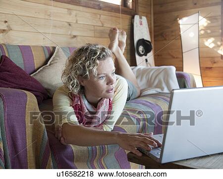 woman in a beach house, using computer View Large Photo Image Stock Photo - woman in a beach house, using computer. Fotosearch
