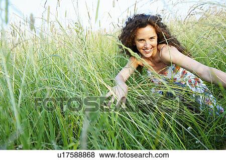 Stock Photo - Woman in a wheat field. Fotosearch