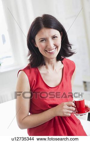 woman in red dress holding red cup View Large Photo Image Picture - woman in red dress holding red cup. Fotosearch
