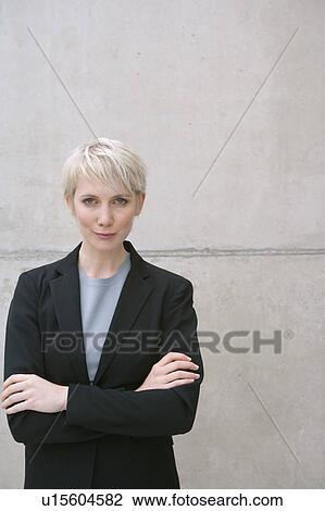 Stock Image - woman in suit arms crossed. Fotosearch