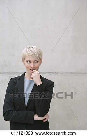 Stock Photo - woman in suit thinking. Fotosearch