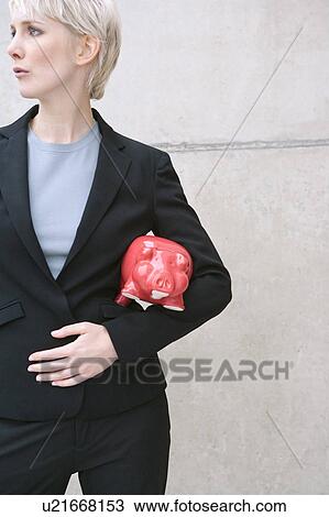 Stock Image - woman in suit with piggy bank. Fotosearch