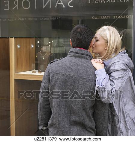Stock Photo - woman kissing man. Fotosearch