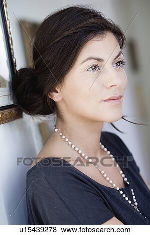 Stock Photo - woman leaning at wall. Fotosearch