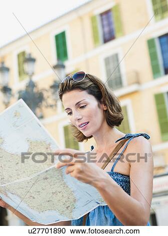Stock Image - woman looking at a map. Fotosearch