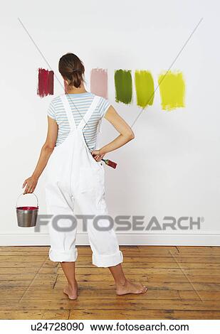 Woman looking at colour swatches on wall View Large Photo Image Stock Image - Woman looking at colour swatches on wall. Fotosearch