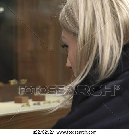 Stock Photo - woman looking at shop window. Fotosearch