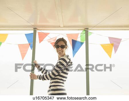 Stock Photo - Woman looking to camera past bunting. Fotosearch