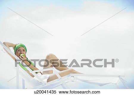 woman lying in a sun lounger View Large Photo Image Stock Photography - woman lying in a sun lounger. Fotosearch