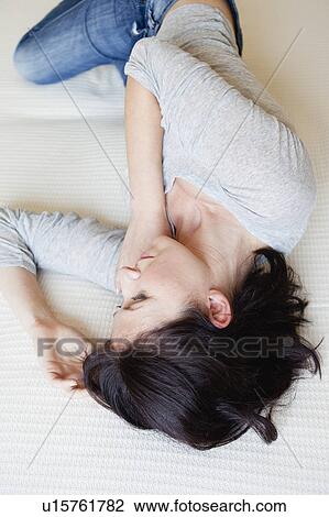 woman lying on bed View Large Photo Image Stock Image - woman lying on bed. Fotosearch