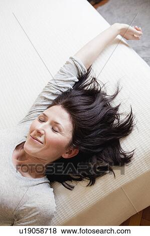 Stock Photo - woman lying on bed. Fotosearch