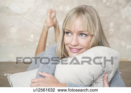 woman lying on floor with pillow View Large Photo Image Stock Image - woman lying on floor with pillow. Fotosearch