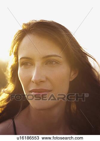 woman on the beach enjoying sunset View Large Photo Image Stock Image - woman on the beach enjoying sunset. Fotosearch