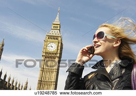Woman on the phone, next to big ben View Large Photo Image Stock Photography - Woman on the phone, next to big ben. Fotosearch