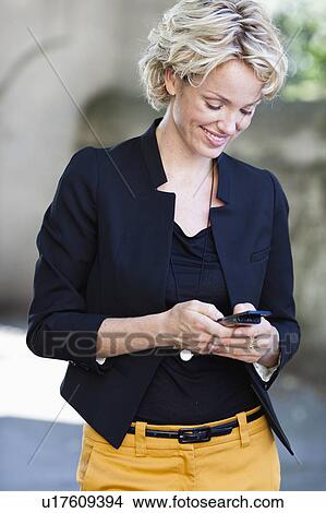 woman operating cell phone View Large Photo Image Picture - woman operating cell phone. Fotosearch