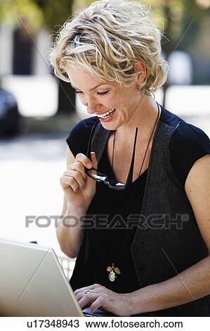 Stock Image - woman operating laptop. Fotosearch
