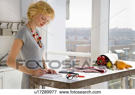 Stock Photo - Woman paying bills. Fotosearch