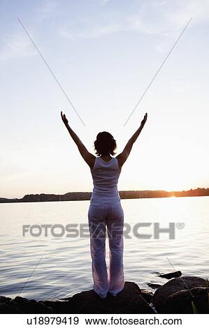 Woman Performing Yoga At Lakeside View Large Photo Image Stock Photo - Woman Performing Yoga At Lakeside. Fotosearch