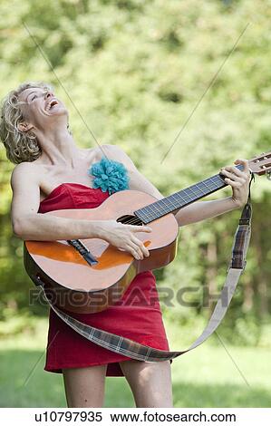 Stock Photography - woman playing guitar. Fotosearch