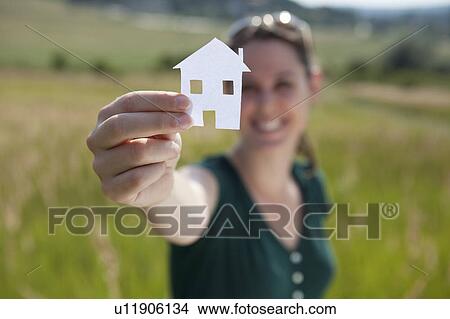 Woman raising cut-out paper house View Large Photo Image Picture - Woman raising cut-out paper house. Fotosearch