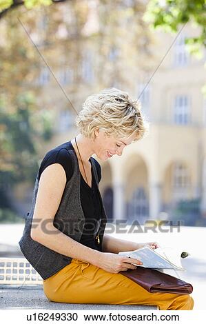 Stock Image - woman reading magazine. Fotosearch
