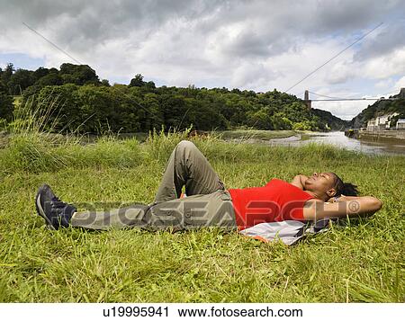 woman relaxing by river View Large Photo Image Stock Image - woman relaxing by river. Fotosearch