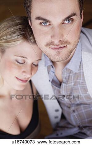 Stock Image - woman resting head on mans shoulder. Fotosearch