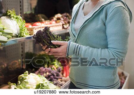 Stock Image - woman shopping for vegetables. Fotosearch
