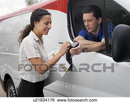 woman signing for delivery from driver View Large Photo Image Stock Photograph - woman signing for delivery from driver. Fotosearch