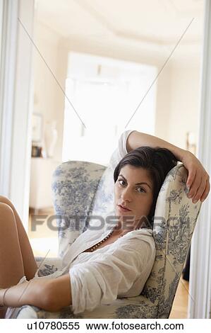 Stock Photography - woman sitting in a chair. Fotosearch