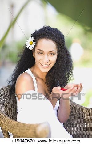 woman sitting in a garden chair View Large Photo Image Stock Image - woman sitting in a garden chair. Fotosearch
