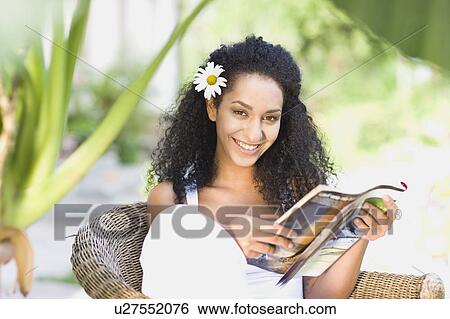 woman sitting in a garden chair View Large Photo Image Stock Photograph - woman sitting in a garden chair. Fotosearch