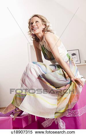 woman sitting on gift wrapped parcels View Large Photo Image Stock Photography - woman sitting on gift wrapped parcels. Fotosearch