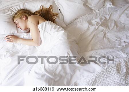 Stock Photo - Woman sleeping in bed. Fotosearch