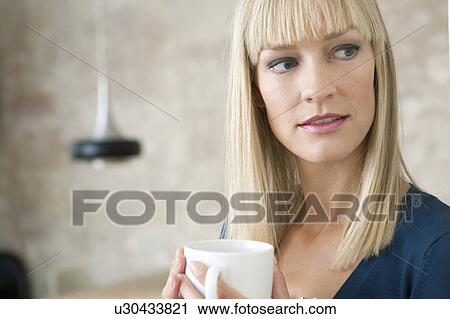 woman smiling and holding cup View Large Photo Image Stock Image - woman smiling and holding cup. Fotosearch