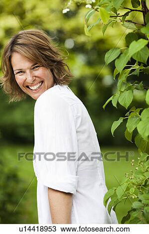 Stock Image - woman smiling at viewer. Fotosearch