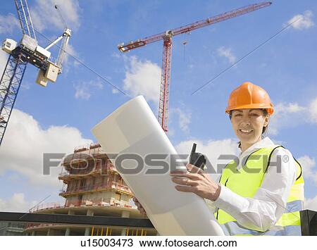 Stock Image - Woman Surveying at Building Site. Fotosearch