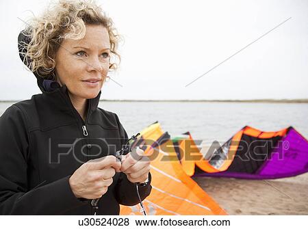 woman tying rope to kite View Large Photo Image Stock Photo - woman tying rope to kite. Fotosearch