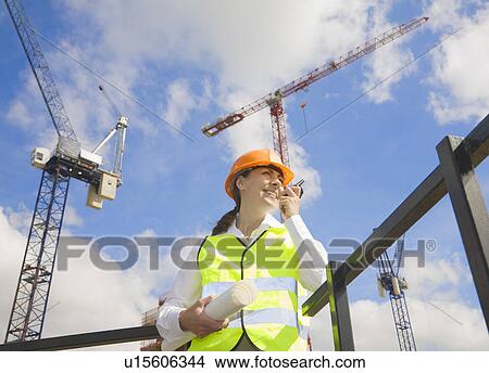 Woman using Walkie Talkie by Cranes View Large Photo Image Picture - Woman using Walkie Talkie by Cranes. Fotosearch